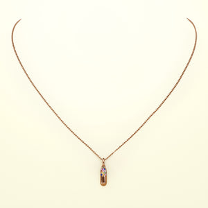 Eine Halskette in Form einer Kapsel, aus fairem Roségold mit Regenbogen Saphiren. Von FENA daily Jewellery